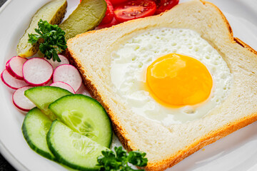 Fried gashouse eggs in bread egg in the basket delicious snack breakfast in a bowl fresh delicious gourmet food background on the table rustic food top view copy space