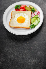 Fried gashouse eggs in bread egg in the basket delicious snack breakfast in a bowl fresh delicious gourmet food background on the table rustic food top view copy space