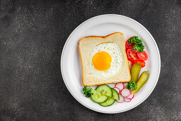 Fried gashouse eggs in bread egg in the basket delicious snack breakfast in a bowl fresh delicious gourmet food background on the table rustic food top view copy space