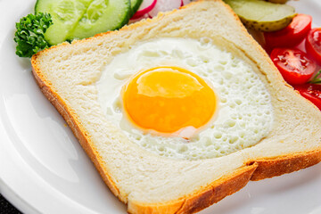 Fried gashouse eggs in bread egg in the basket delicious snack breakfast in a bowl fresh delicious gourmet food background on the table rustic food top view copy space