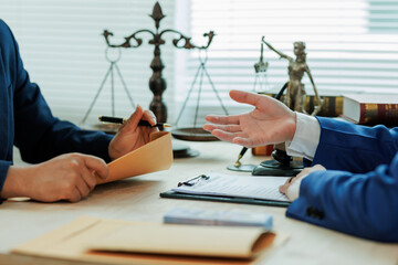 A client meets with a lawyer to discuss a legal case and seek professional representation for...