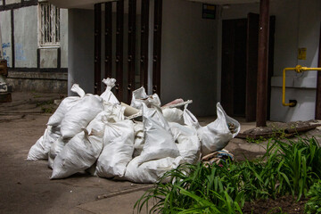 construction waste in bags, packed a lot, lying at the door, in the yard of the house, thrown away,...