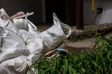 construction waste in bags, a lot of garbage, packed, lying at the door, in the yard of the house,...