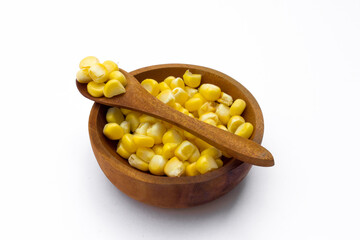 A wooden bowl with corn kernels, isolated on white background.