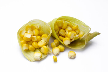 Corn kernels inside a leaf that comes from a corn husk bent into a cone. This photo can be a culinary concept or idea or container for corn kernels.