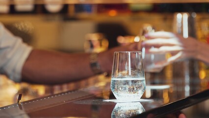 Closeup bartender hand in poring fresh soda gas texture into glass of drink advertisement serving customer at beverage bar counter luxury pub for welcome impression greeting guess service. Vinosity.