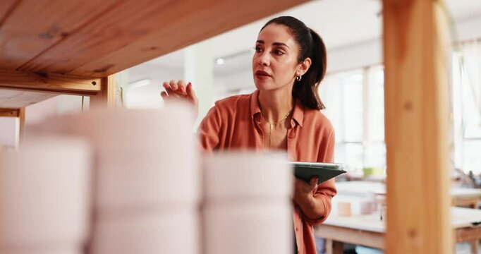 Pottery, shop owner and woman with tablet to check quality, inventory and design in store. Startup business, ceramic warehouse and tech with online order, stock or invoice by shelf for product