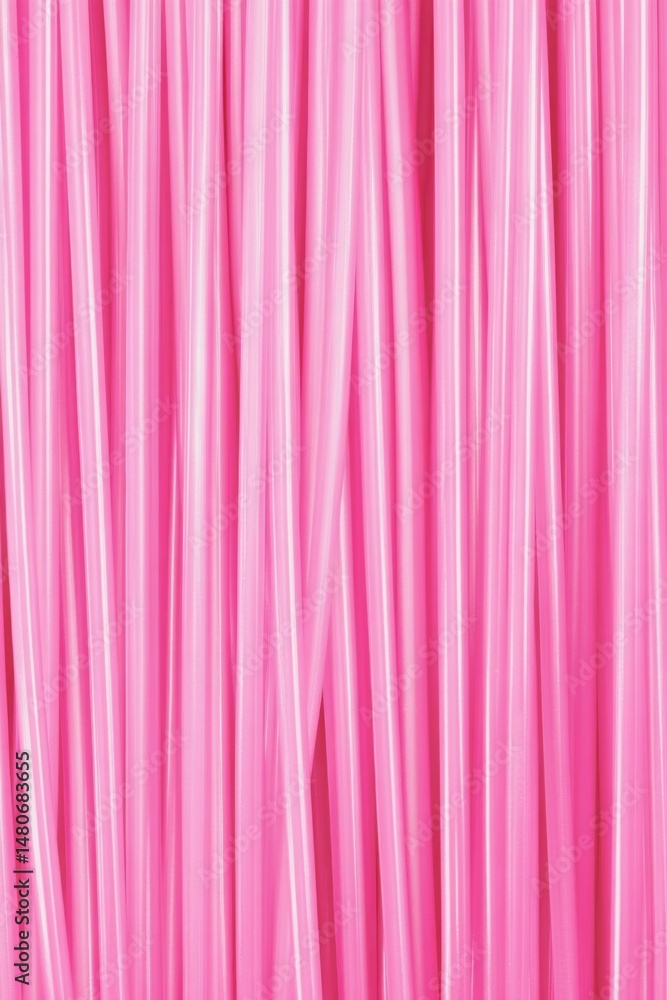 Poster pink straws arranged vertically in a close up view, creating a vibrant and playful pattern for summe