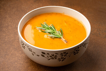 Delicious lentil, ezogelin or pumpkin soup on brown stone background