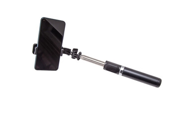 Selfie stick with phone on white background