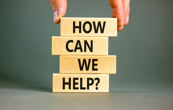 How can we help symbol. Concept words How can we help on beautiful wooden blocks. Beautiful grey table grey background. Businessman hand. Business and how can we help concept. Copy space.