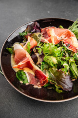 Salad food jamon meat green leaf lettuce appetizer natural fresh gourmet food background on the table rustic food top view copy space keto and paleo diet