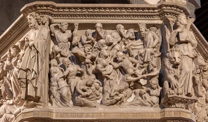  PISTOIA, ITALY - MARCH 16, 2025: The marble relief of Massacre of Inocents on the medieval pulpit in the church Pieve di Sant'Andrea by Giovanni Pisano from year 1301. © Renáta Sedmáková