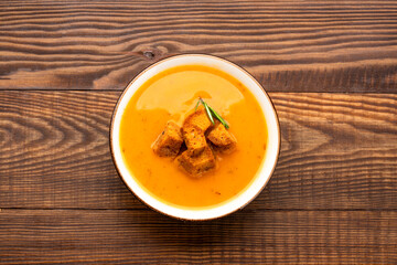 Delicious lentil, ezogelin or pumpkin soup on wooden background