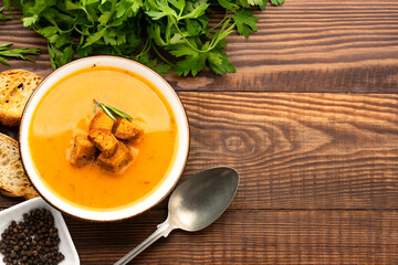 Delicious lentil, ezogelin or pumpkin soup on wooden background