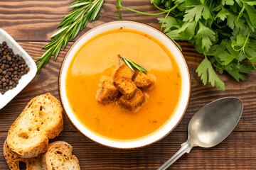 Delicious lentil, ezogelin or pumpkin soup on wooden background