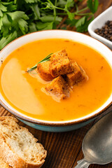 Delicious lentil, ezogelin or pumpkin soup on wooden background