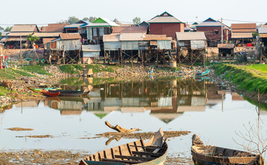 Rural Khmer houses on stilts,and old boats,at Phnom Krom village,near Tonle Sap lake,Cambodia.