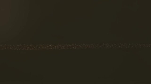 Glowing gold light particle trails on a black background