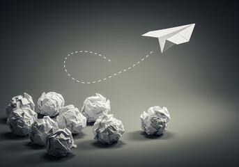 Successful Idea Taking Flight Above Crumpled Paper Balls Representing Failed Attempts and Challenges