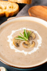 Delicious and healthy mushroom soup on black background
