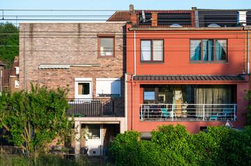 Back facade of houses in a row along the railway tracks in Ruisbroek, Flemish Brabant, Belgium