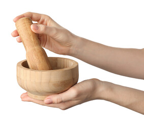 Woman with mortar and pestle on light background, closeup