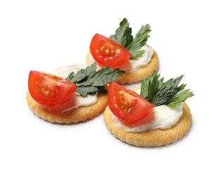 Tasty crackers with cream cheese, tomatoes and parsley isolated on white