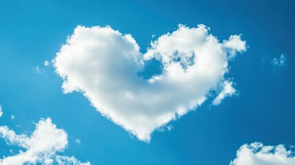 Heart-shaped cloud in a clear blue sky captured during midday