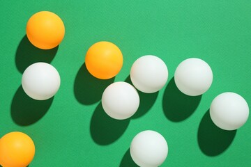 Ping pong balls on green background, flat lay