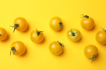 Ripe yellow cherry tomatoes on color background, flat lay