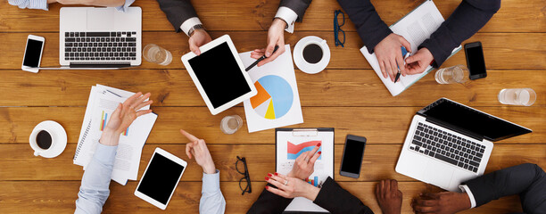 Business meeting top view. Multiethnic busy people work in office