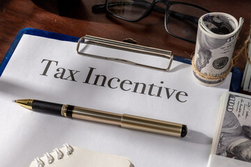 A formal tax incentive record clipped and placed on a clean office work surface.