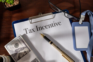 Incentive-related tax form organized in a clipboard, placed on a structured office desk.