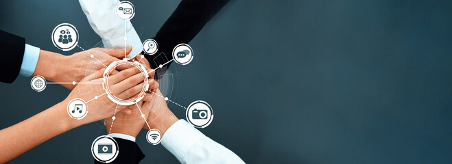 This image captures a powerful representation of teamwork, showcasing hands coming together in a...