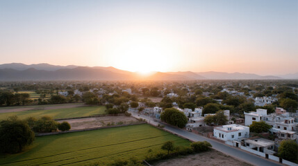 Obraz premium aerial view of urban sprawl in india during golden hour showcasing soft light of sunset