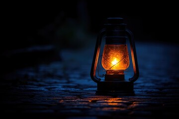 Single vintage lantern casting warm glow in dark night.