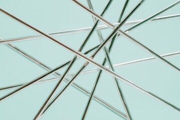Obraz premium Abstract design of intersecting metallic lines on a pastel background.