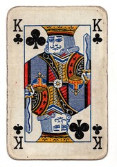 A well worn playing card in the suit of clubs isolated on a white background.