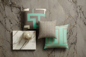 Decorative throw pillows arranged on a marble surface.