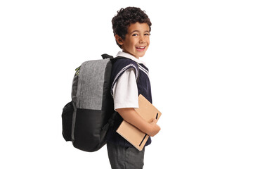 Asian schoolboy in a uniform standing and holding a book