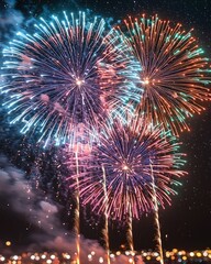 Vibrant fireworks display explodes against a night sky, illuminating the cityscape below with colorful bursts and trails of light