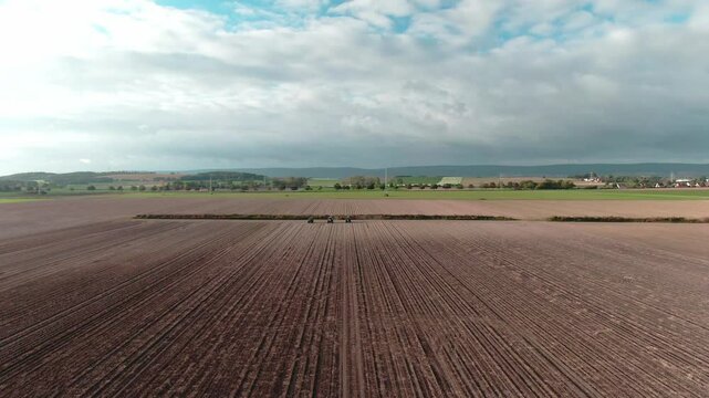 Drone Footage of Tractors Driving and Standing on Farmland &ndash; Aerial View of Agricultural Machinery in Action