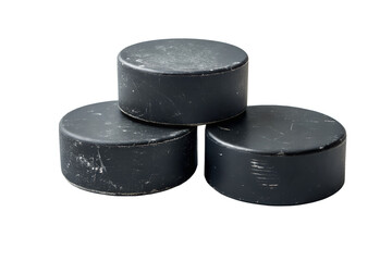 Three black ice hockey pucks neatly stacked in a stable pyramid displayed on a solid white background