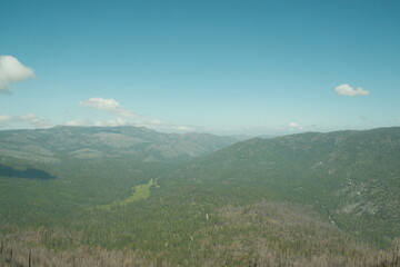 Yosemite National Park in California’s Sierra Nevada mountains green foliage on sunny day beautiful landscape