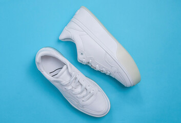 White sneakers on a blue background.