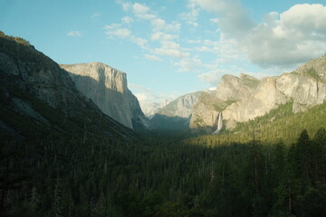 Yosemite National Park in California’s Sierra Nevada mountains green foliage on sunny day beautiful landscape