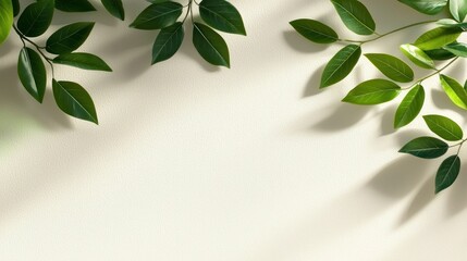 Green leaves surround blank cream paper with soft lighting