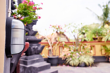 Outdoor Wall Lamp with Garden View in Tropical Setting..
