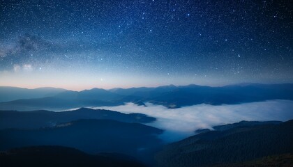 Fototapeta premium View of beautiful night sky with stars in foggy mountain valley.